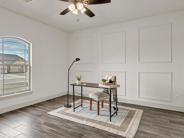 office featuring visible vents, ceiling fan, baseboards, and wood finished floors