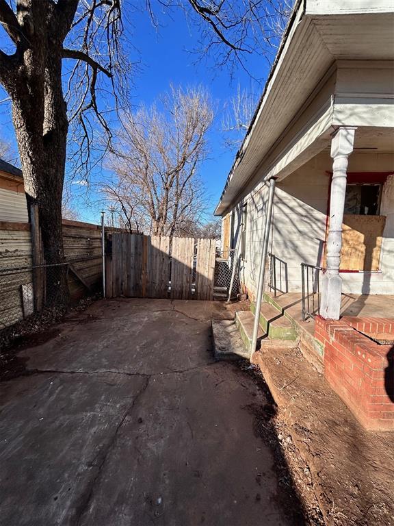 view of side of property featuring a patio area and fence