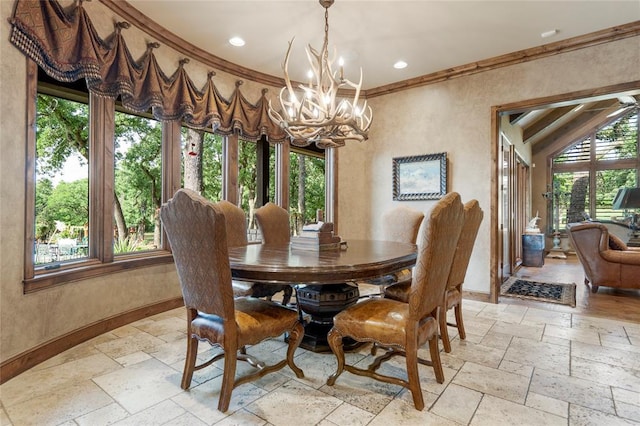 dining area with stone tile floors, baseboards, ornamental molding, a wealth of natural light, and an inviting chandelier