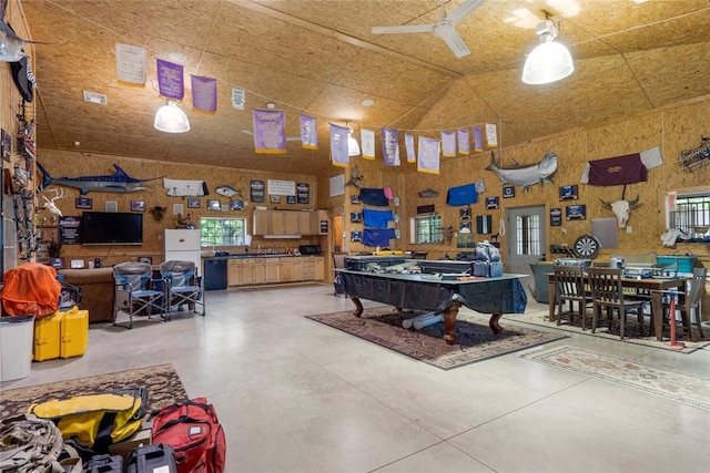 interior space with high vaulted ceiling, plenty of natural light, and concrete floors