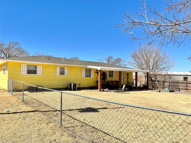 rear view of property featuring fence