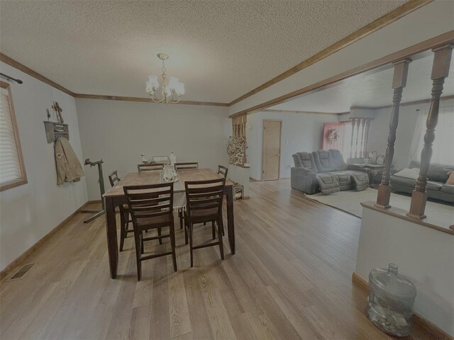 707 S Third St, Cheyenne, OK 73628 - dining room featuring a textured ceiling, light wood finished floors, a chandelier, and crown molding