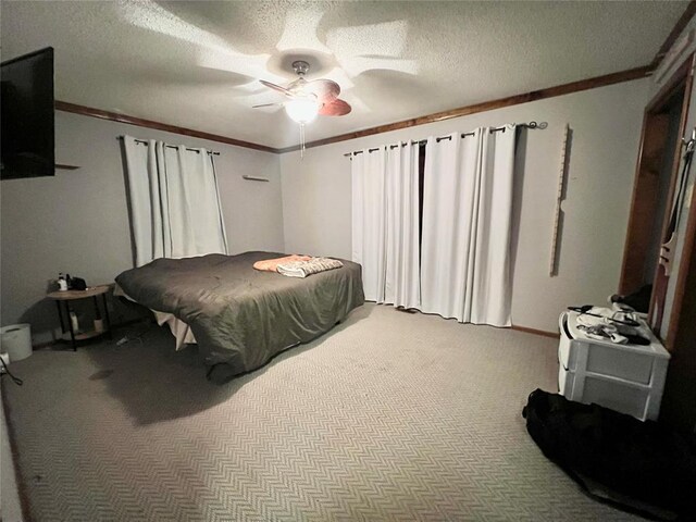 707 S Third St, Cheyenne, OK 73628 - bedroom with carpet flooring, ornamental molding, a textured ceiling, and ceiling fan