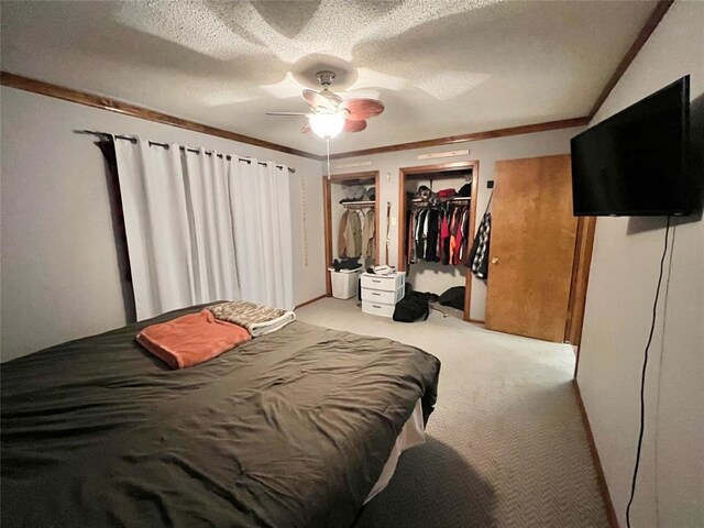 707 S Third St, Cheyenne, OK 73628 - bedroom with light colored carpet, two closets, a ceiling fan, a textured ceiling, and crown molding