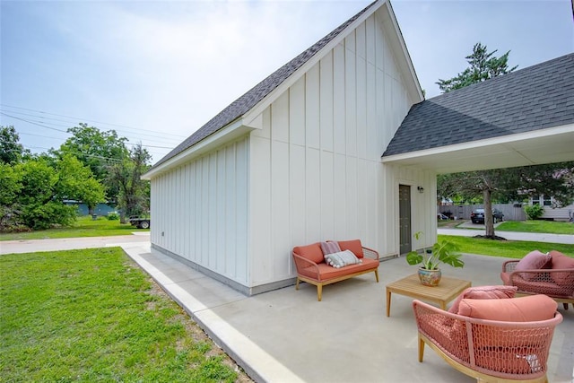 1027 S 7th St, Chickasha, OK 73018 - view of side of property featuring a shingled roof, board and batten siding, a yard, and a patio area
