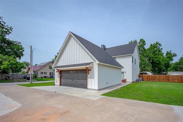 1027 S 7th St, Chickasha, OK 73018 - view of side of home featuring a shingled roof, board and batten siding, a chimney, and central AC