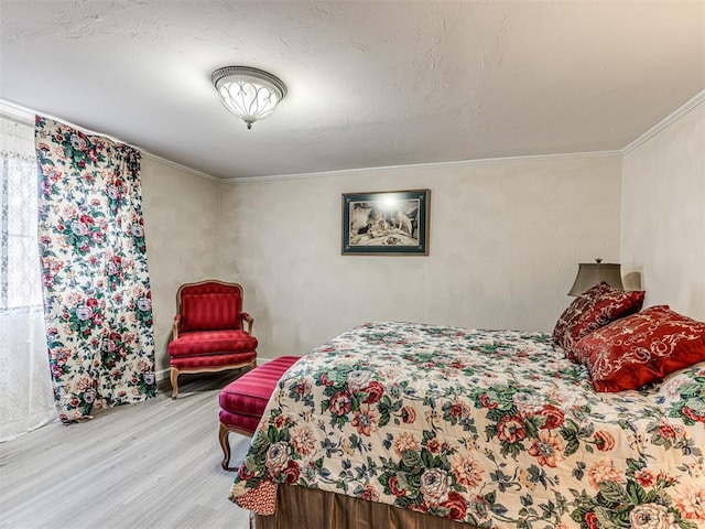 bedroom featuring light wood-style floors and ornamental molding