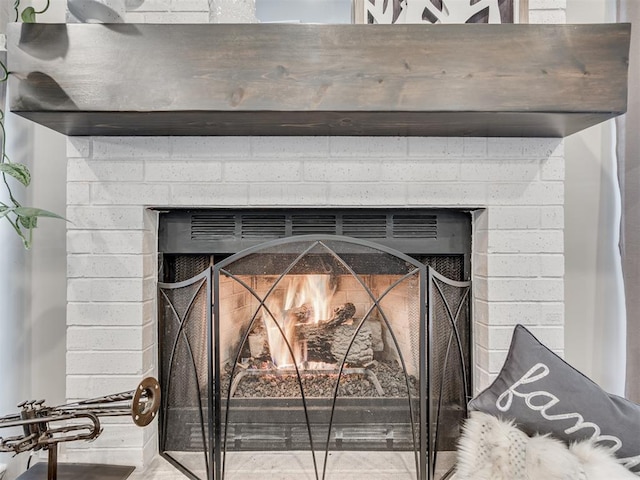 interior details with a brick fireplace