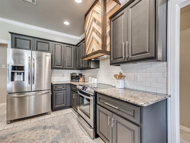 kitchen with light stone countertops, appliances with stainless steel finishes, gray cabinets, and backsplash