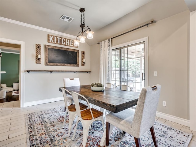 dining space with light tile patterned floors, ornamental molding, visible vents, and baseboards