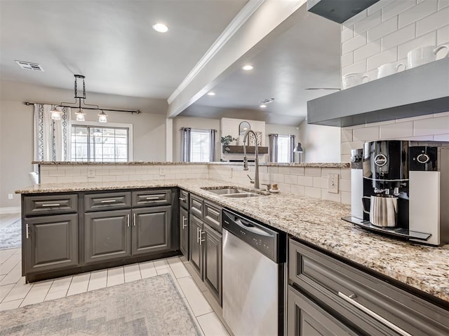 kitchen featuring tasteful backsplash, visible vents, a sink, light stone countertops, and dishwasher