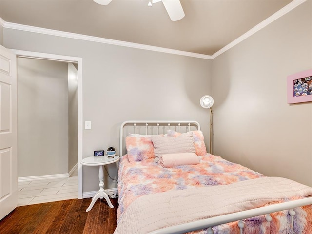 bedroom with ceiling fan, baseboards, crown molding, and wood finished floors