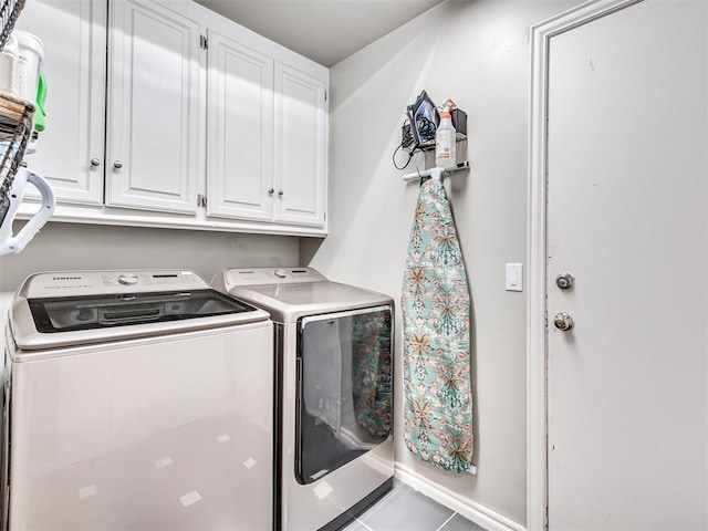 laundry room with tile patterned flooring, cabinet space, and independent washer and dryer