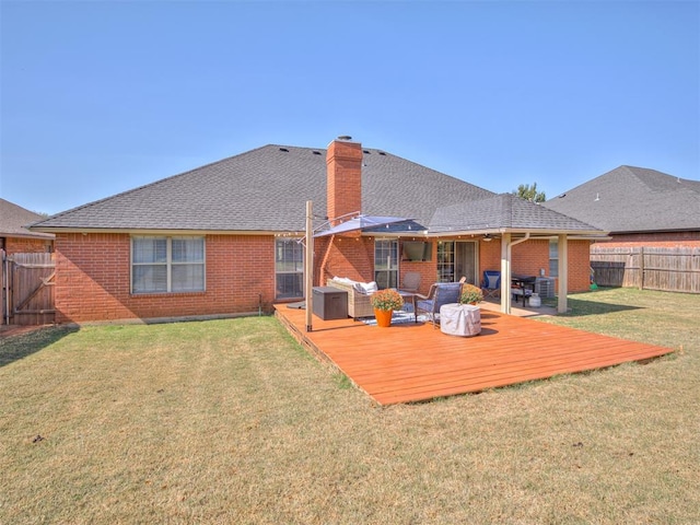 back of house with a wooden deck, a fenced backyard, a yard, an outdoor living space, and brick siding