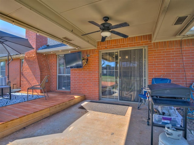 view of patio featuring visible vents, a ceiling fan, and a wooden deck