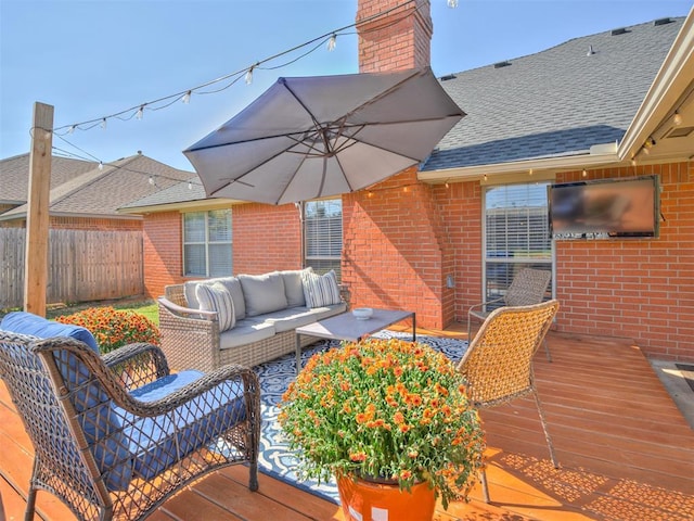 wooden deck featuring outdoor lounge area and fence