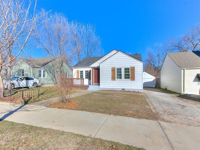 view of front of property with aphalt driveway, crawl space, a front lawn, and fence