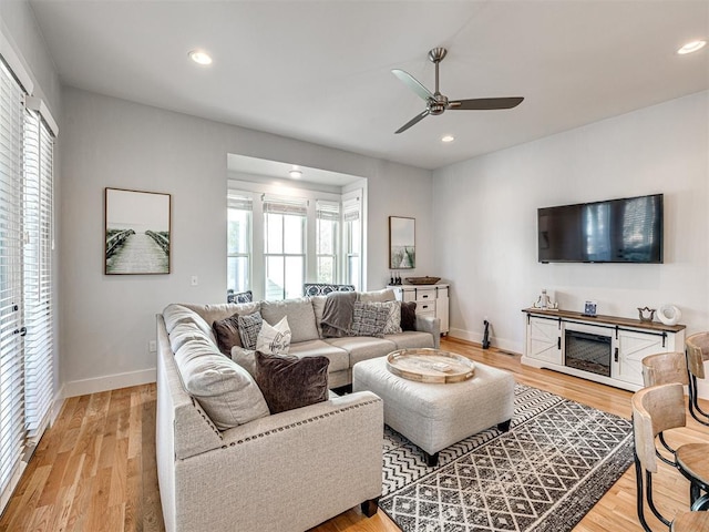 living area with recessed lighting, ceiling fan, baseboards, and wood finished floors