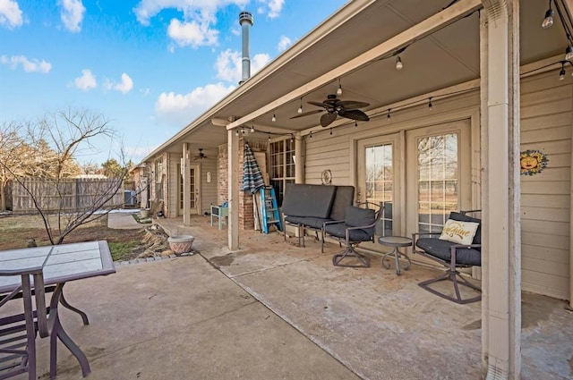 view of patio with ceiling fan and fence