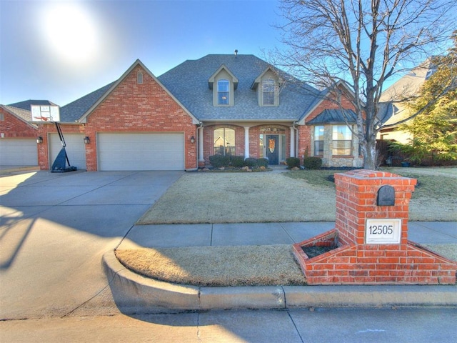 view of front of house featuring a garage, brick siding, driveway, and roof with shingles