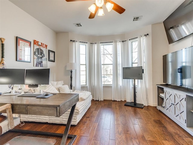 interior space featuring ceiling fan, dark wood finished floors, visible vents, and baseboards