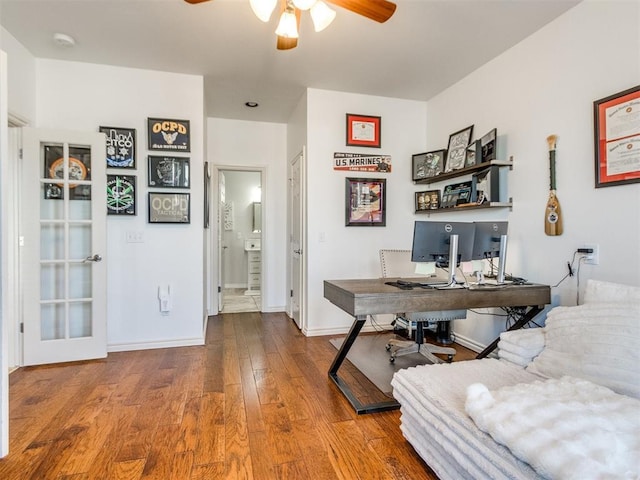 office featuring ceiling fan, baseboards, and wood finished floors