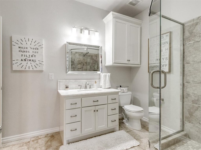 bathroom featuring visible vents, baseboards, toilet, vanity, and a shower stall