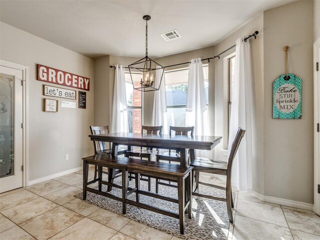 dining space with visible vents, baseboards, and an inviting chandelier