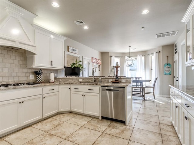 kitchen with visible vents, white cabinets, wall chimney exhaust hood, appliances with stainless steel finishes, and pendant lighting