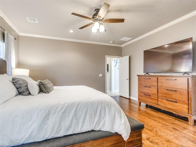 bedroom featuring crown molding, visible vents, light wood-style floors, ceiling fan, and baseboards