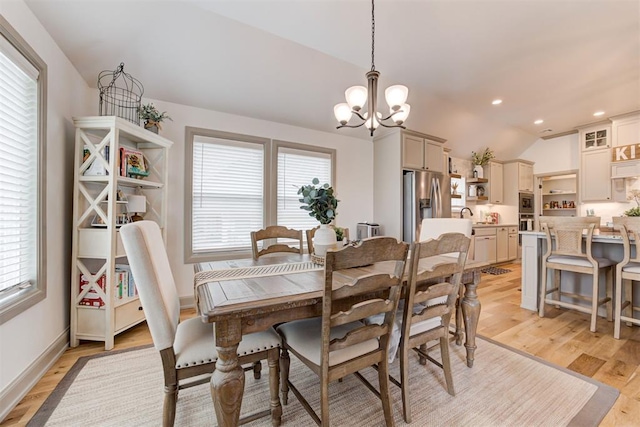 dining room featuring a notable chandelier, lofted ceiling, recessed lighting, light wood-style floors, and baseboards