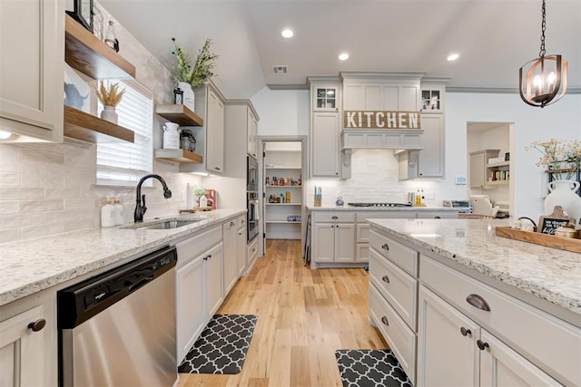 kitchen with open shelves, stainless steel appliances, hanging light fixtures, white cabinets, and a sink