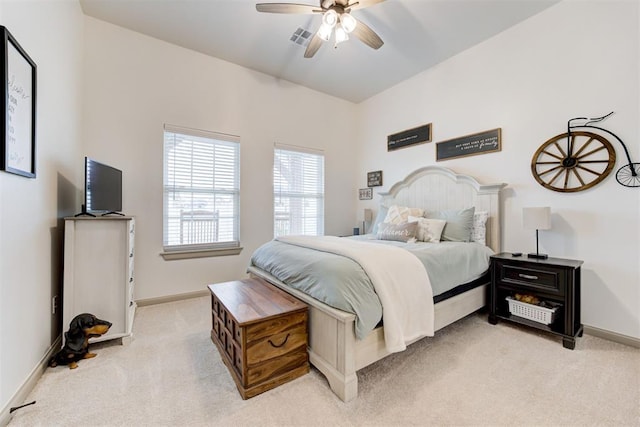 bedroom featuring light carpet, visible vents, baseboards, and a ceiling fan