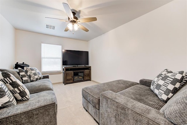 living area featuring light carpet, ceiling fan, visible vents, and baseboards