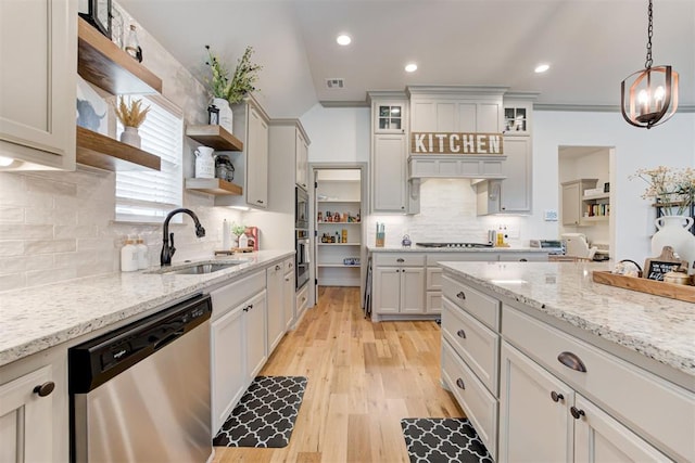 kitchen featuring tasteful backsplash, open shelves, visible vents, a sink, and stainless steel appliances