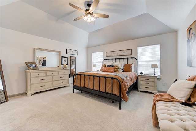 bedroom featuring light carpet, ceiling fan, baseboards, and vaulted ceiling