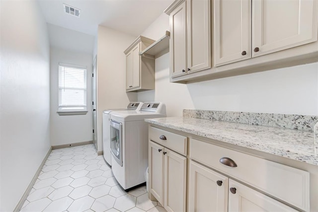laundry room featuring cabinet space, visible vents, baseboards, and washer and dryer