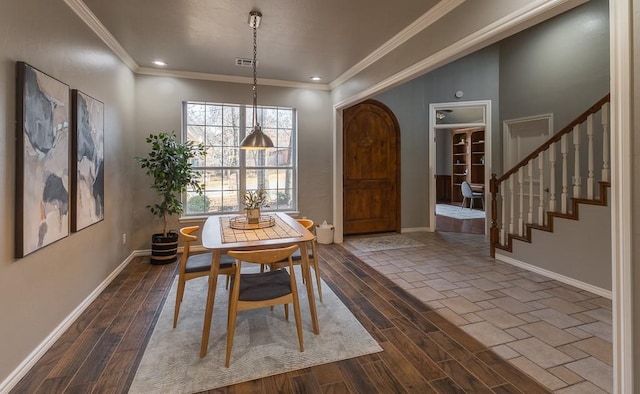 dining room with wood tiled floor, crown molding, stairway, and baseboards