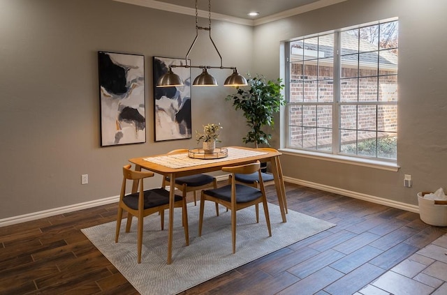 dining room with baseboards, crown molding, and wood finish floors