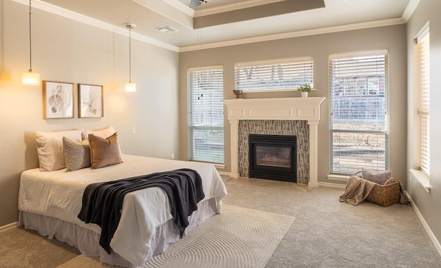 bedroom with crown molding, a fireplace, a raised ceiling, visible vents, and light carpet