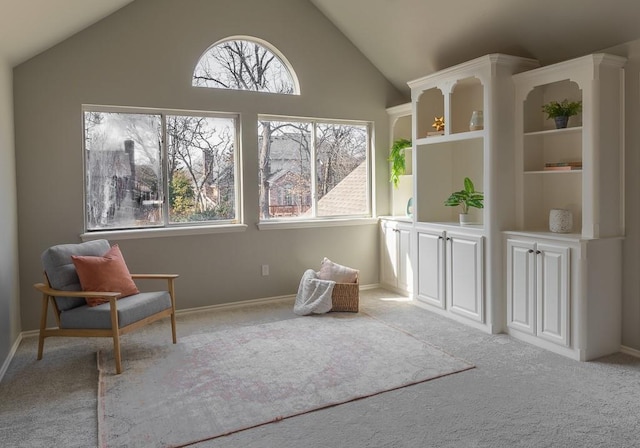 unfurnished room featuring light carpet and vaulted ceiling