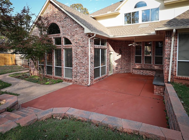 exterior space featuring ceiling fan and fence