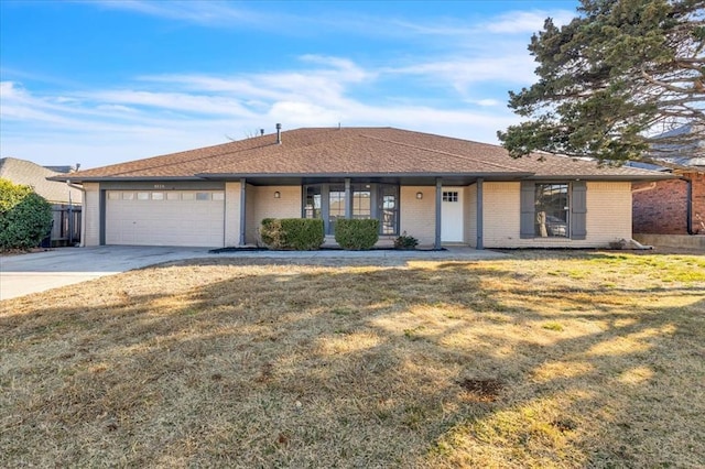 single story home with brick siding, a shingled roof, concrete driveway, an attached garage, and a front lawn