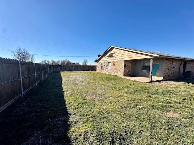 view of yard featuring central air condition unit and a fenced backyard