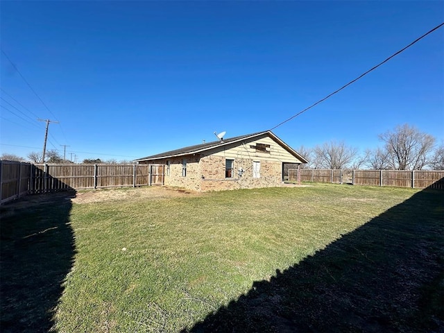 view of yard with a fenced backyard