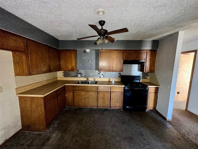 kitchen with brown cabinetry, light countertops, black range with electric stovetop, and a sink