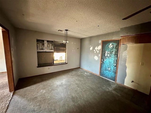 empty room with visible vents and a textured ceiling