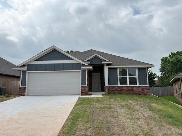 3438 NW 178th Ter, Edmond, OK 73012 - view of front facade featuring brick siding, an attached garage, board and batten siding, concrete driveway, and a shingled roof