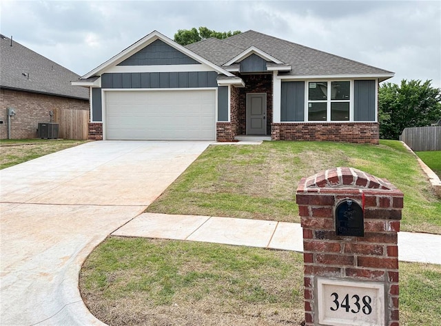 3438 NW 178th Ter, Edmond, OK 73012 - craftsman house with board and batten siding, brick siding, an attached garage, and roof with shingles