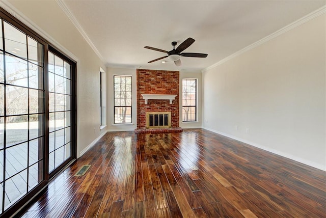 unfurnished living room featuring dark wood-style floors, a brick fireplace, visible vents, and crown molding